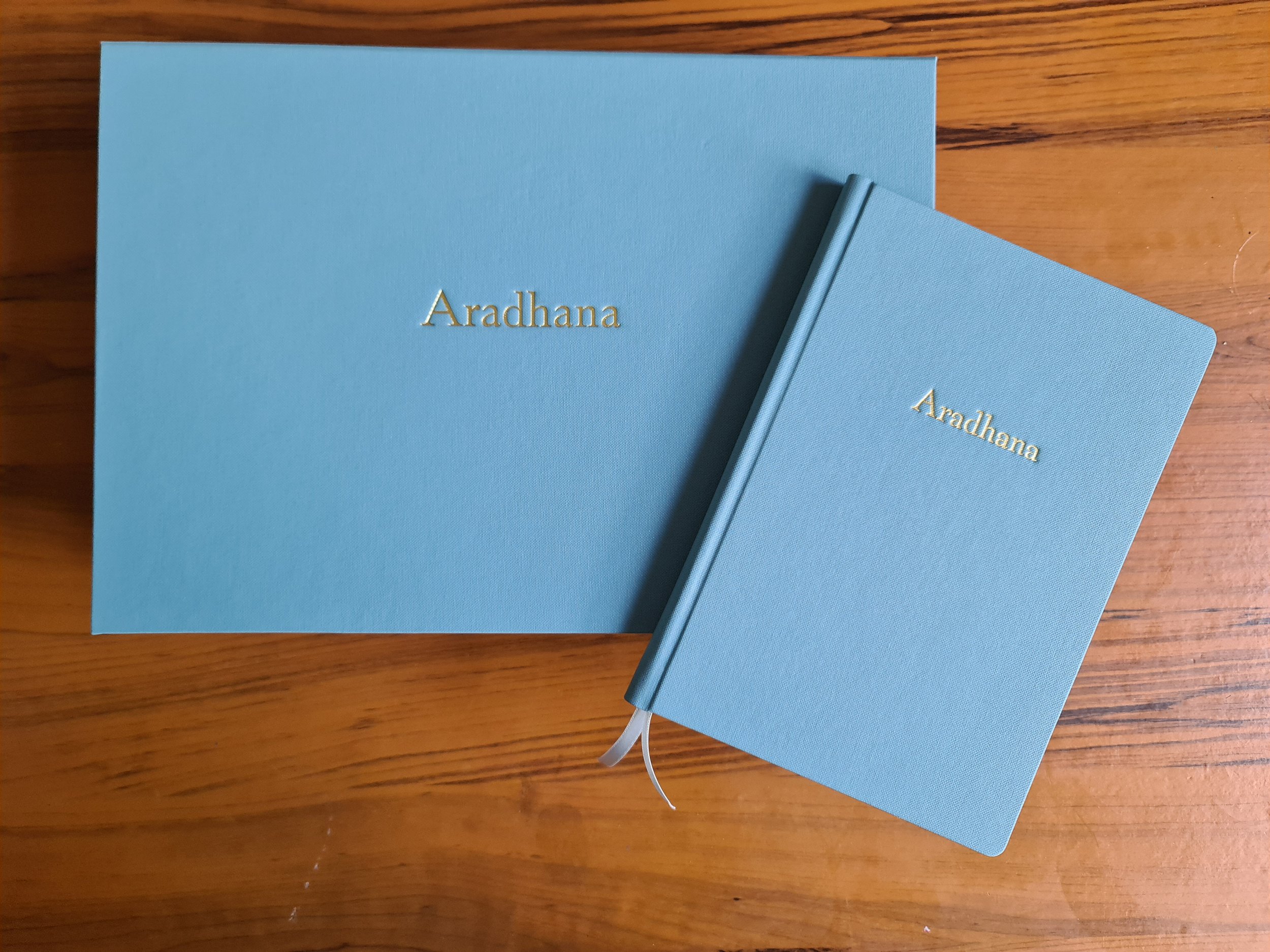 Blue box closed on table with book laying on top